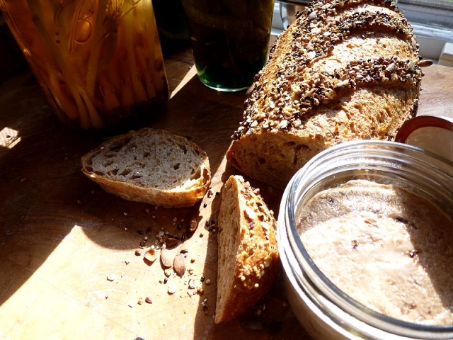 Super-seedy bread, jars of pickles, and jars of rillettes