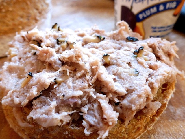 A slice of baguette with truffle-studded duck rillettes