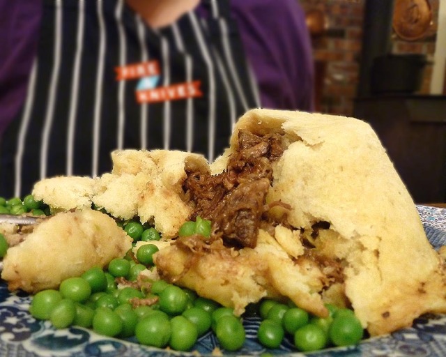 Savory oxtail & kidney pudding contained in the tender steamed pastry
